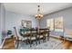 Elegant dining room with chandelier, wood table, and decorative rug, perfect for entertaining at 16585 W Harrison St, Goodyear, AZ 85338