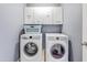 This laundry room features a washer and dryer with Wash, Fold, Dry, Repeat cabinets at 16585 W Harrison St, Goodyear, AZ 85338