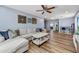 Bright living room features wood floors, neutral paint, and a comfortable sectional sofa at 16585 W Harrison St, Goodyear, AZ 85338