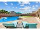 Sparkling pool with a waterfall feature, lounge chairs and patio area at 16585 W Harrison St, Goodyear, AZ 85338