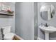 Stylish powder room with pedestal sink and modern fixtures. Fresh paint at 16585 W Harrison St, Goodyear, AZ 85338