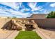 Backyard featuring a rock waterfall feature and small grass patch at 16629 E Westby Dr, Fountain Hills, AZ 85268