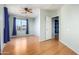 Bright bedroom featuring a ceiling fan, large window with curtains, and hard wood flooring at 16629 E Westby Dr, Fountain Hills, AZ 85268