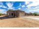 Single-story home with neutral stucco, tile roof, and desert landscaping under a cloudy sky at 16629 E Westby Dr, Fountain Hills, AZ 85268