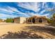 Low-angle shot of a home with a tile roof and desert landscaping under a cloudy blue sky at 16629 E Westby Dr, Fountain Hills, AZ 85268