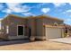 Beige house featuring a two car garage, neutral trim, and desert landscaping at 16629 E Westby Dr, Fountain Hills, AZ 85268