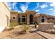 Charming single-story home featuring a desert landscape, arched entryway and tile roof at 16629 E Westby Dr, Fountain Hills, AZ 85268