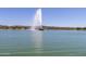 Scenic lake view featuring a large water fountain and lakeside homes in the distance at 16629 E Westby Dr, Fountain Hills, AZ 85268