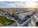 Scenic aerial shot of homes in a Primary-planned community backed by mountains and golf course at 1697 E Tangelo Pl, Queen Creek, AZ 85140