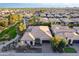 Expansive aerial view of a beige single-Gathering home in a residential neighborhood with desert landscaping at 1697 E Tangelo Pl, Queen Creek, AZ 85140