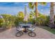 Cozy patio table with umbrella and four chairs, surrounded by lush greenery at 1697 E Tangelo Pl, Queen Creek, AZ 85140