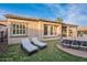 Relaxing backyard with lounge chairs and covered patio at 1697 E Tangelo Pl, Queen Creek, AZ 85140