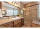 Modern bathroom featuring tile floor and walls, a glass shower enclosure, and a granite vanity countertop at 1697 E Tangelo Pl, Queen Creek, AZ 85140