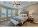 Serene bedroom with plantation shutters, king bed, and elegant furnishings at 1697 E Tangelo Pl, Queen Creek, AZ 85140