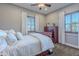 Cozy bedroom with a plush bed, shuttered windows, and neutral decor at 1697 E Tangelo Pl, Queen Creek, AZ 85140