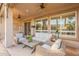 Relaxing covered patio featuring wicker seating, ceiling fans, and a peaceful outdoor ambiance at 1697 E Tangelo Pl, Queen Creek, AZ 85140