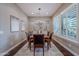 Formal dining room with hardwood floors, plantation shutters, and a chandelier at 1697 E Tangelo Pl, Queen Creek, AZ 85140