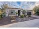 Charming single-story home featuring desert landscaping, a brick driveway, and a two-car garage at 1697 E Tangelo Pl, Queen Creek, AZ 85140