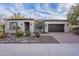 Charming single-story home featuring desert landscaping, a brick driveway, and a two-car garage at 1697 E Tangelo Pl, Queen Creek, AZ 85140