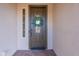 Elegant front door with decorative wreath and sidelight, offering a warm welcome at 1697 E Tangelo Pl, Queen Creek, AZ 85140