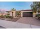 Beautiful home featuring a paver driveway, well manicured landscaping, and a 2-car garage at 1697 E Tangelo Pl, Queen Creek, AZ 85140