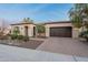 Charming single-story home with a desert landscaped yard and convenient two-car garage at 1697 E Tangelo Pl, Queen Creek, AZ 85140