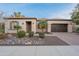 Charming home with manicured desert landscaping, rock features, and a two car garage at 1697 E Tangelo Pl, Queen Creek, AZ 85140