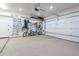 Well-organized garage interior featuring epoxy flooring, storage racks, bikes, and a clean, bright space at 1697 E Tangelo Pl, Queen Creek, AZ 85140