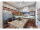 Spacious kitchen with stainless steel appliances, granite countertops, and wooden cabinetry at 1697 E Tangelo Pl, Queen Creek, AZ 85140