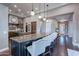 Bright kitchen with granite countertops, pendant lighting, and seating at the island at 1697 E Tangelo Pl, Queen Creek, AZ 85140