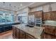 Open-concept kitchen with a center island, stainless steel appliances, and abundant cabinet space at 1697 E Tangelo Pl, Queen Creek, AZ 85140