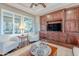 Living room with built-in cabinetry, plantation shutters, and a comfortable seating area at 1697 E Tangelo Pl, Queen Creek, AZ 85140