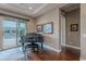 Elegant living room featuring a grand piano and sliding glass doors to the outside at 1697 E Tangelo Pl, Queen Creek, AZ 85140