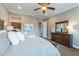 A brightly illuminated main bedroom features a ceiling fan, carpet flooring, crown molding, and neutral paint at 1697 E Tangelo Pl, Queen Creek, AZ 85140