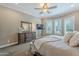 The main bedroom is illuminated by recessed lighting and features shuttered windows and carpeted floor at 1697 E Tangelo Pl, Queen Creek, AZ 85140