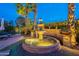 Elegant water feature surrounded by lush landscaping with ambient lighting at 1697 E Tangelo Pl, Queen Creek, AZ 85140