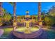 Elegant water feature surrounded by lush landscaping with ambient lighting at 1697 E Tangelo Pl, Queen Creek, AZ 85140