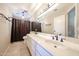 Bathroom featuring double sinks with black fixtures and a shower with a brown shower curtain at 17104 E Rand Dr, Fountain Hills, AZ 85268