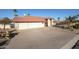 Charming single-story home featuring a three-car garage, desert landscaping, and a red tile roof at 17104 E Rand Dr, Fountain Hills, AZ 85268