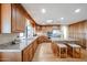 Charming kitchen featuring wood cabinets, granite counters, a center island, and stainless appliances at 17104 E Rand Dr, Fountain Hills, AZ 85268