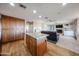 Open kitchen featuring granite countertops, wood cabinets, a center island, and hardwood floors at 17104 E Rand Dr, Fountain Hills, AZ 85268