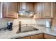 Close-up of a kitchen counter featuring modern appliances and wood cabinets for a gourmet experience at 17104 E Rand Dr, Fountain Hills, AZ 85268