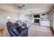 Bright living room featuring tile floors, ceiling fans, a fireplace, built-ins and comfortable seating at 17104 E Rand Dr, Fountain Hills, AZ 85268