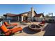 Spacious backyard patio featuring lounge chairs, a swing, and a fire pit, perfect for outdoor relaxation and entertainment at 17104 E Rand Dr, Fountain Hills, AZ 85268