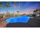 Inviting pool surrounded by palm trees and desert scenery on a spacious deck at 17104 E Rand Dr, Fountain Hills, AZ 85268