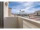 Balcony view of the neighborhood street with palm trees, showcasing the surrounding community and blue skies at 1750 E Ocotillo Rd # 11, Phoenix, AZ 85016