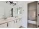 Bathroom featuring double sinks, white cabinets, and an open doorway to the shower at 1750 E Ocotillo Rd # 11, Phoenix, AZ 85016