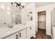 Bathroom featuring double sinks, white cabinets, and glass shower at 1750 E Ocotillo Rd # 11, Phoenix, AZ 85016