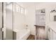 Bright bathroom featuring a shower, bathtub, and an open doorway to the bedroom at 1750 E Ocotillo Rd # 11, Phoenix, AZ 85016