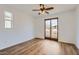 Bedroom with wood-look floors and sliding glass doors leading to a balcony at 1750 E Ocotillo Rd # 11, Phoenix, AZ 85016